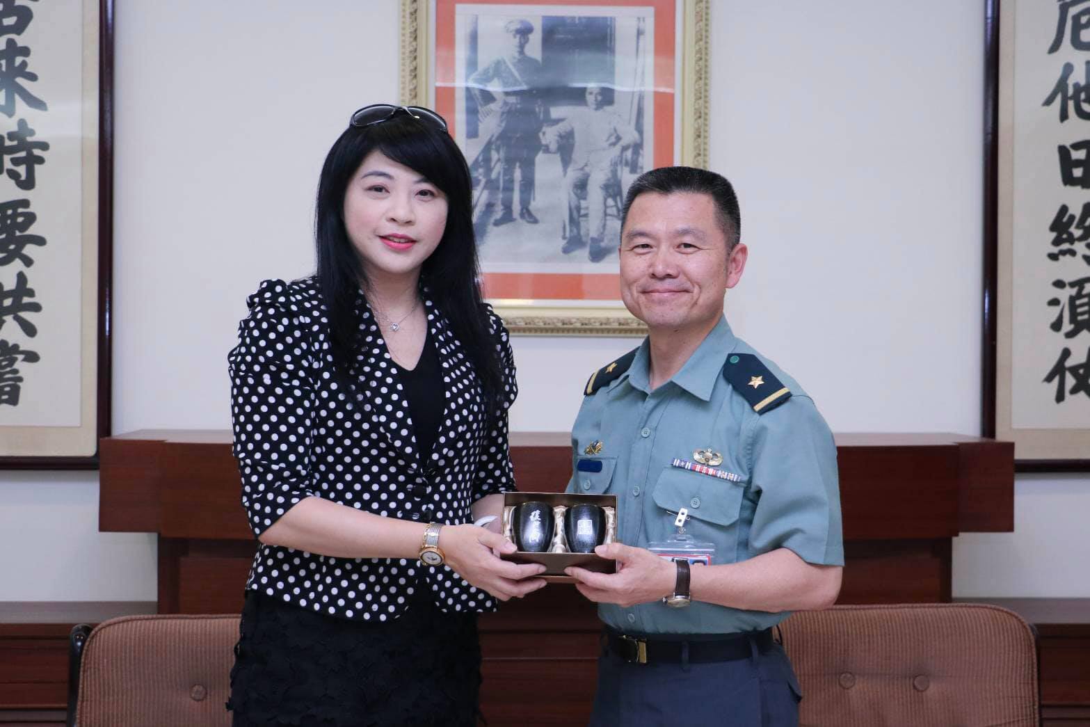 The commander gives the teacher a gift.